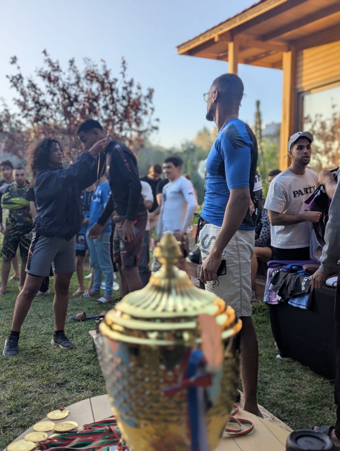 Athletes gathering around the trophy