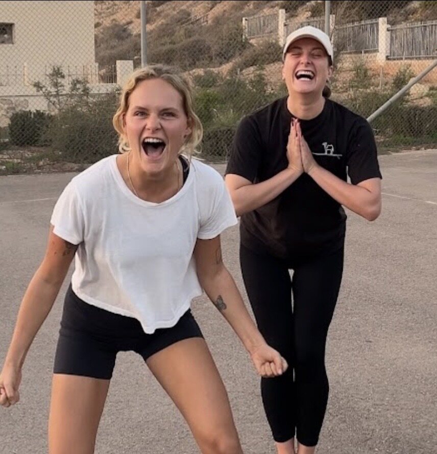 Two women celebrating outdoors